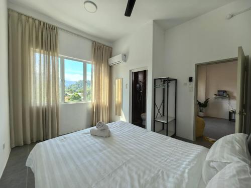 Voodi või voodid majutusasutuse Langkawi Simfoni Lavanya Suite 07 toas