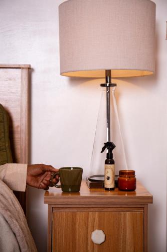 a lamp on a table with a bowl on it at Chumbys in Lagos