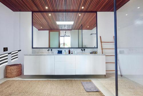 a bathroom with a sink and a large mirror at Amazing 3BDR-Villa Canggu/Seseh 2min walk to Beach in Canggu
