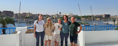 a group of people posing for a picture on a boat at La Terrace in Aswan