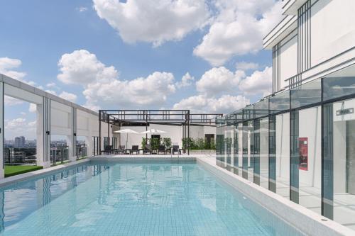 a swimming pool on the roof of a building at SZ Canalside Hotel in Bangkok