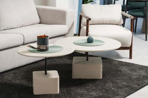 a living room with two tables and a couch at SeeSea Hotel in Vodice