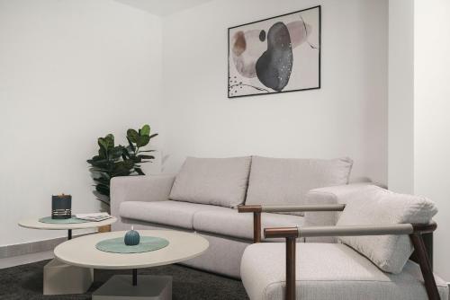 a living room with a couch and two tables at SeeSea Hotel in Vodice
