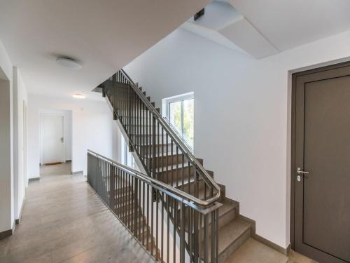 a staircase in a white room with a door at CityVibe Apartment für bis zu 4 in Erlangen