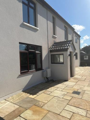 a white building with a window and a roof at Cedarwood B&B in Felton