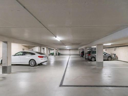 a parking garage with cars parked in it at Bright Apartment für bis zu 5 Erlangen in Erlangen