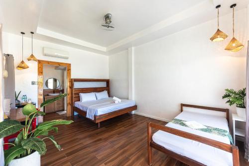a bedroom with two beds in a room at YAMA APARTMENTS - Private Beachfront in General Luna