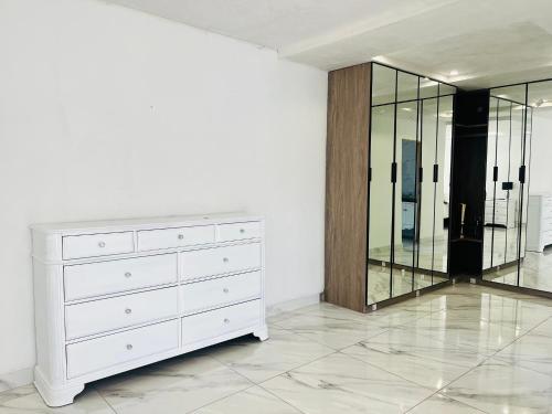 a white dresser in a room with a mirror at Mafjoint2 in Zeerust