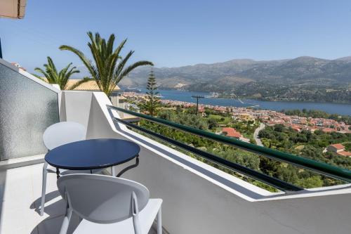 a balcony with a table and chairs overlooking the water at Studios Rania - Rania Studios & Apartments in Lassi