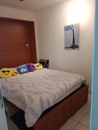 a bedroom with a bed with three pillows on it at Maison à la campagne in Meursac