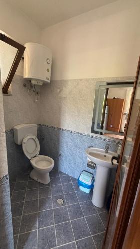 a bathroom with a toilet and a sink at Besart Room in Orikum