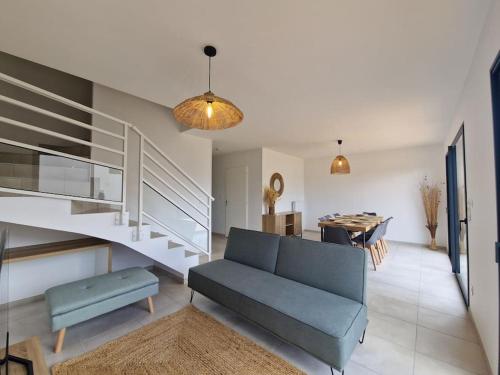 a living room with a blue couch and a table at Le Lisbonne #Climatisation#Terrasse#Parking in Aubière