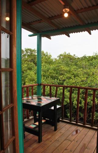 a table on the deck of a house at Peaceful Refuge in Quiete Bay in Bocas del Toro