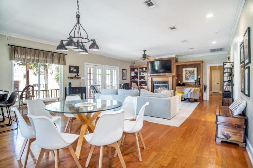 a living room with a table and chairs and a couch at Stunning Riverside Retreat with Private Pool home in Port Vincent
