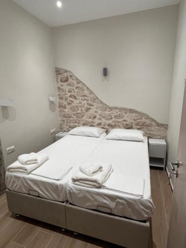 a bedroom with a bed with towels on it at Aphaia Serenity Apartment in Aegina Town