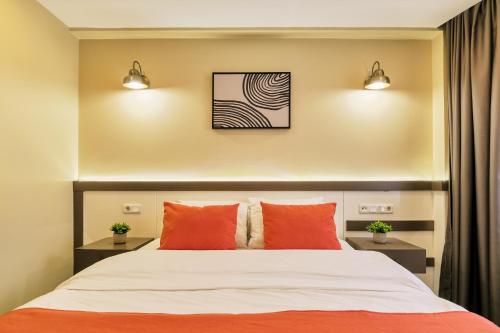 a bedroom with a bed with orange pillows at Duck Otel in Istanbul
