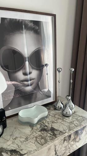 a picture of a woman wearing sunglasses on a table at Home In 2 in Druskininkai