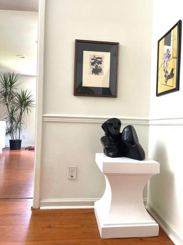 a black sculpture sitting on a stand in a room at Trendy Bohemian Bungalow, Close to Uptown, Plaza & Noda in Charlotte