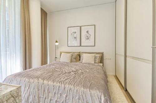 a bedroom with a bed in a white room at Home In 2 in Druskininkai