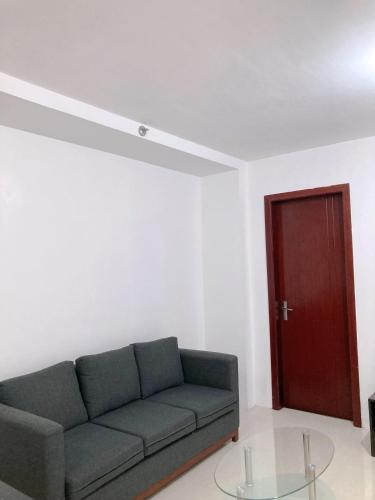 a living room with a couch and a red door at BALAI Condominiums in Lusong