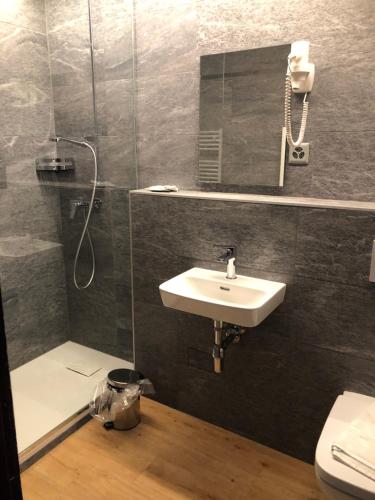 a bathroom with a sink and a shower at Au Bivouac de Napoléon et Spa in Bourg-Saint-Pierre