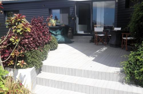 a patio with stairs and plants in front of a house at Apartamento tranquilo e acolhedor in Ponta Delgada