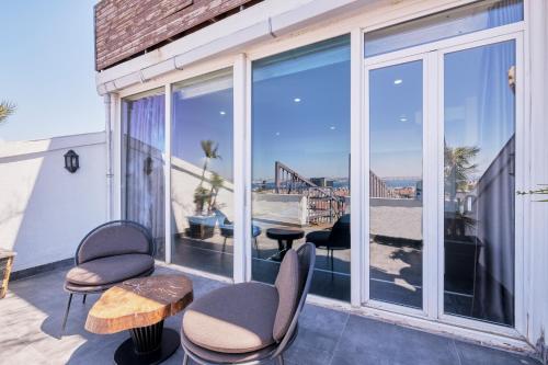 a balcony with chairs and tables and a view of the ocean at Duck Otel in Istanbul