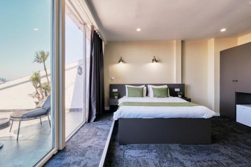a bedroom with a large bed and a large window at Duck Otel in Istanbul
