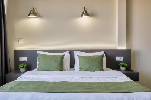 a bedroom with a bed with two green pillows at Duck Otel in Istanbul