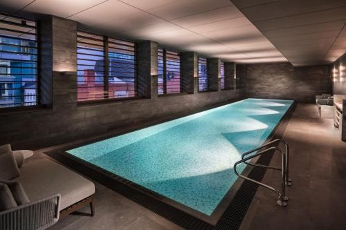 a large swimming pool in a room with windows at Adelaide Marriott Hotel in Adelaide