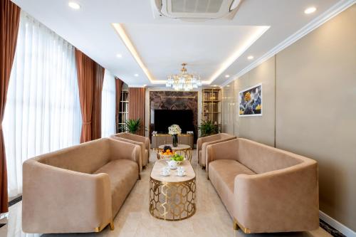 a living room with two couches and a table at Sandals Vista Hotel in Bao Loc