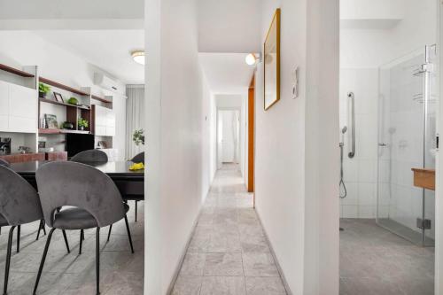 a kitchen and dining room with a table and chairs at Ben Yehuda Elegant City Retreat with Shelter by Sea N Rent in Tel Aviv