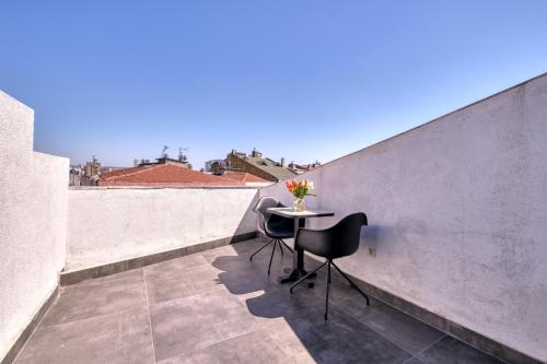 a balcony with a table and chairs on a wall at Duck Otel in Istanbul