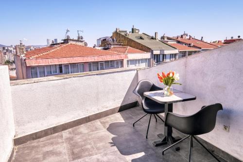 a balcony with a table and chairs on a roof at Duck Otel in Istanbul