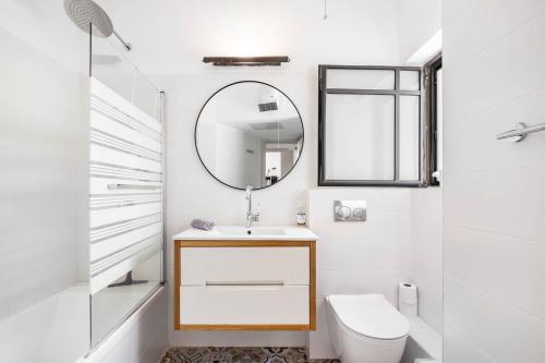 a bathroom with a sink and a mirror at Ramat Hasharon Duplex Rooftop Oasis by Sea N Rent in Ramat Hash Sharon