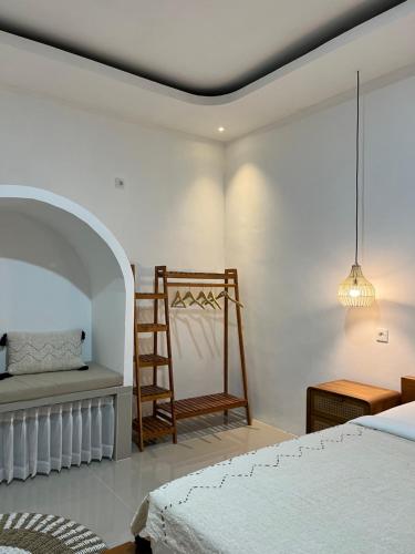a bedroom with a ladder and a bed and a chair at Montana villas by volcano garden in Kubupenlokan