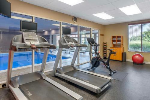 a gym with two exercise bikes and a pool at Hilton Garden Inn Lexington in Lexington