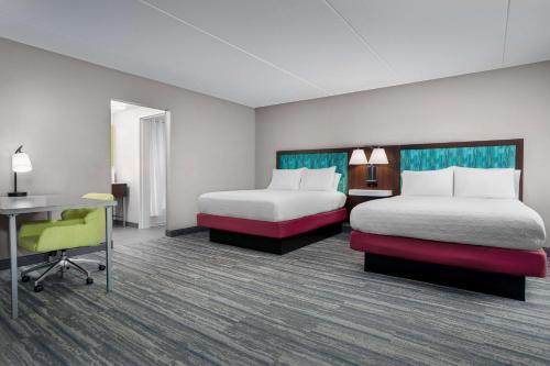 a hotel room with two beds and a desk at Hampton Inn & Suites Atlanta-Six Flags in Lithia Springs