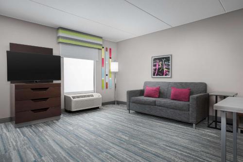 a living room with a couch and a flat screen tv at Hampton Inn & Suites Atlanta-Six Flags in Lithia Springs