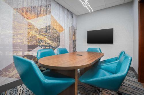 a conference room with a wooden table and blue chairs at Hampton Inn & Suites Atlanta-Six Flags in Lithia Springs