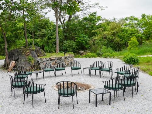 a group of chairs and tables in a park at Bella Basera in Kumbhalgarh