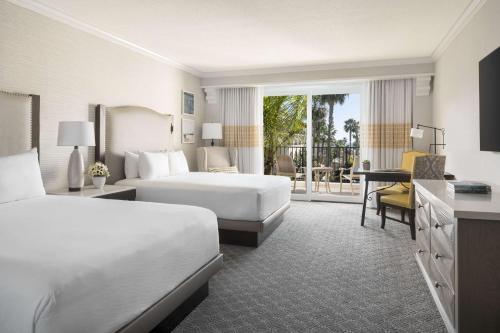 a hotel room with two beds and a balcony at Hyatt Regency Huntington Beach Resort and Spa in Huntington Beach