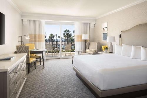 a large hotel room with a bed and a desk at Hyatt Regency Huntington Beach Resort and Spa in Huntington Beach