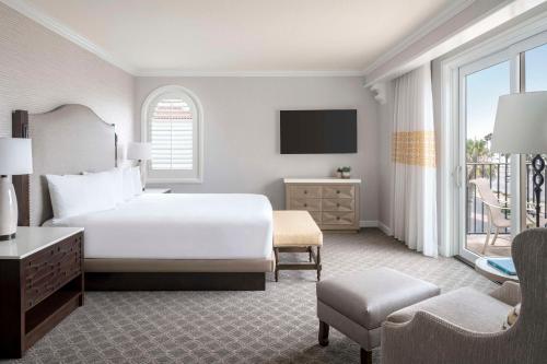 a hotel room with a bed and a balcony at Hyatt Regency Huntington Beach Resort and Spa in Huntington Beach