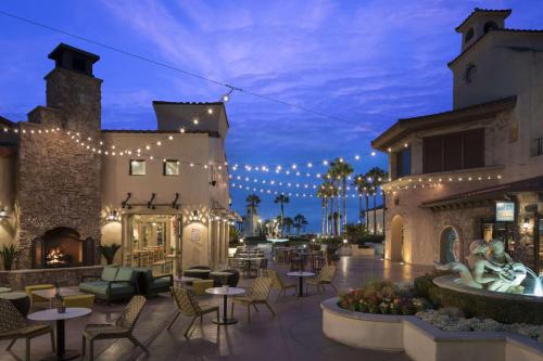 a patio at a resort with lights and tables and chairs at Hyatt Regency Huntington Beach Resort and Spa in Huntington Beach