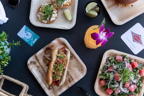 a table topped with plates of food with tacos and a salad at Hyatt Regency Huntington Beach Resort and Spa in Huntington Beach