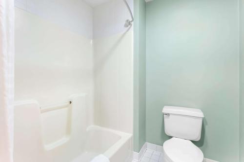 a white bathroom with a toilet and a shower at Quality Inn & Suites Gorham Riverside in Gorham