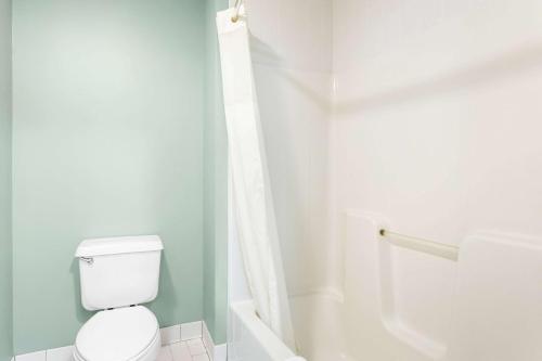 a white bathroom with a toilet and a shower at Quality Inn & Suites Gorham Riverside in Gorham