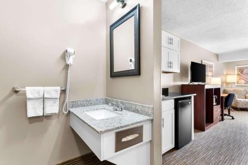 a bathroom with a sink and a mirror at Quality Inn & Suites in Gorham