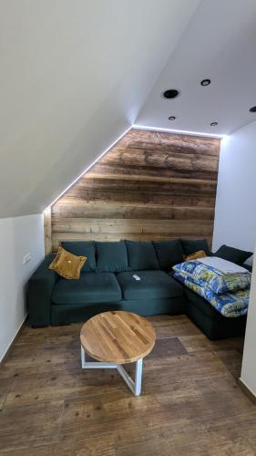 a living room with a blue couch and a table at Król Puszczy - unikatowy dom, jezioro 80m, szlak Krutyni in Ruciane-Nida